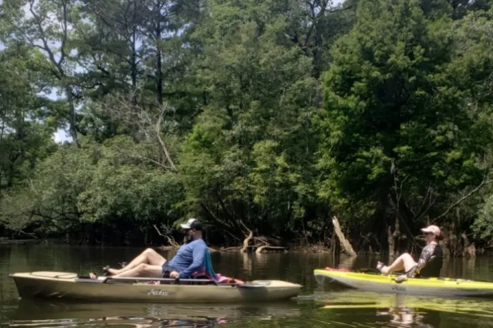 a group of people rowing a boat in the water